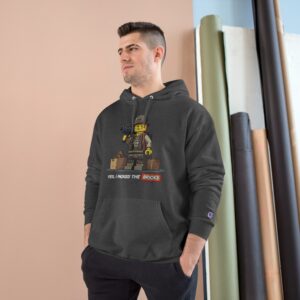 Man wearing LEGO-themed hoodie indoors.