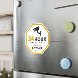 24-hour surveillance warning sticker on metal surface